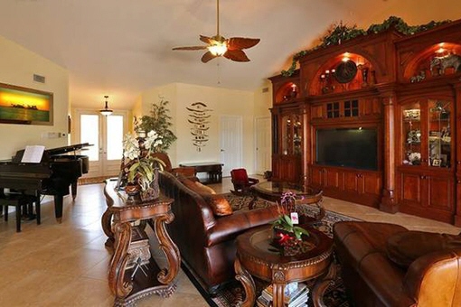 Living area with grand and ceiling fans in Fort Myers